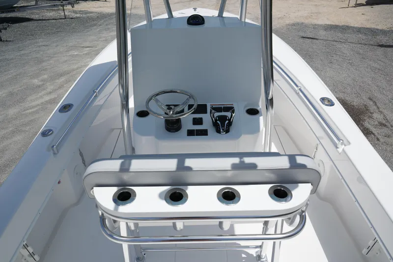 Slide: The Image of 2025 Contender 25T boat console with steering wheel and rod holders. - 7