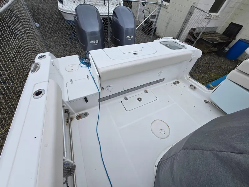 Slide: The Image of 2020 Sea Hunt Gamefish 25 boat deck with dual 150 engines, white interior. - 10