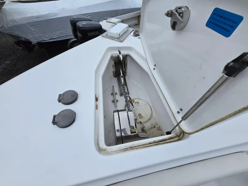 Slide: The Image of 2020 Sea Hunt Gamefish 25 anchor compartment with open hatch and visible anchor chain. - 11