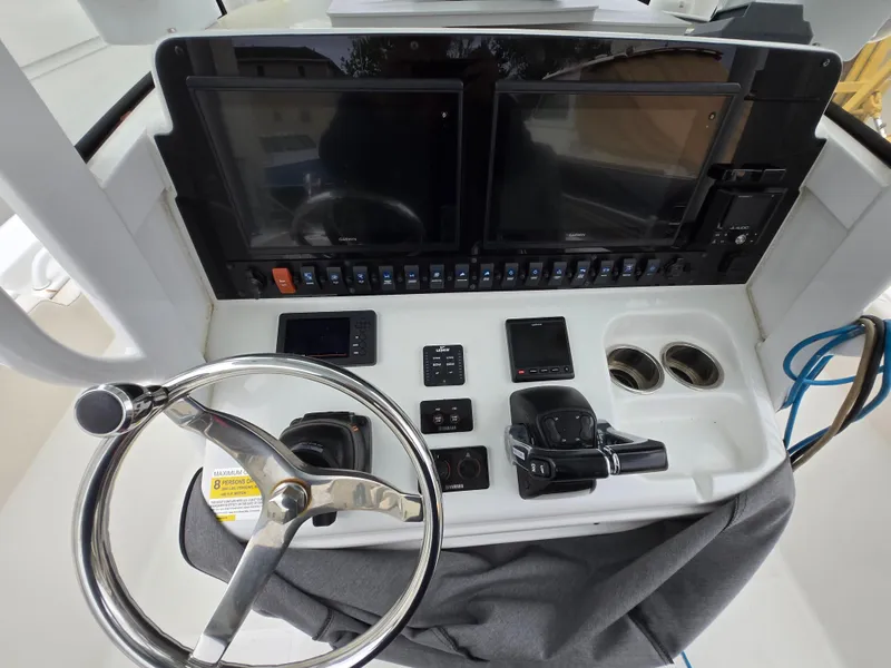 Slide: The Image of 2020 Sea Hunt Gamefish 25 helm with dual screens and steering wheel. - 14