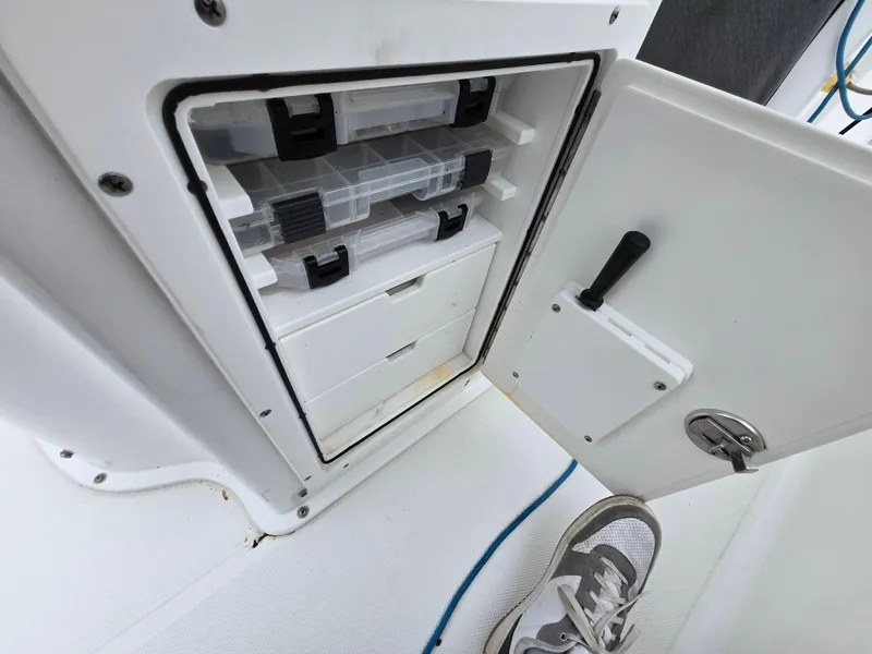 Slide: The Image of Storage compartment on a 2020 Sea Hunt Gamefish 25 boat with tackle boxes. - 22