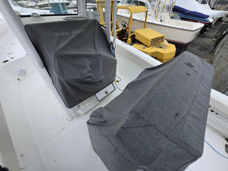 Slide: The Image of 2020 Sea Hunt Gamefish 25 boat interior with covered console and seating. - 23