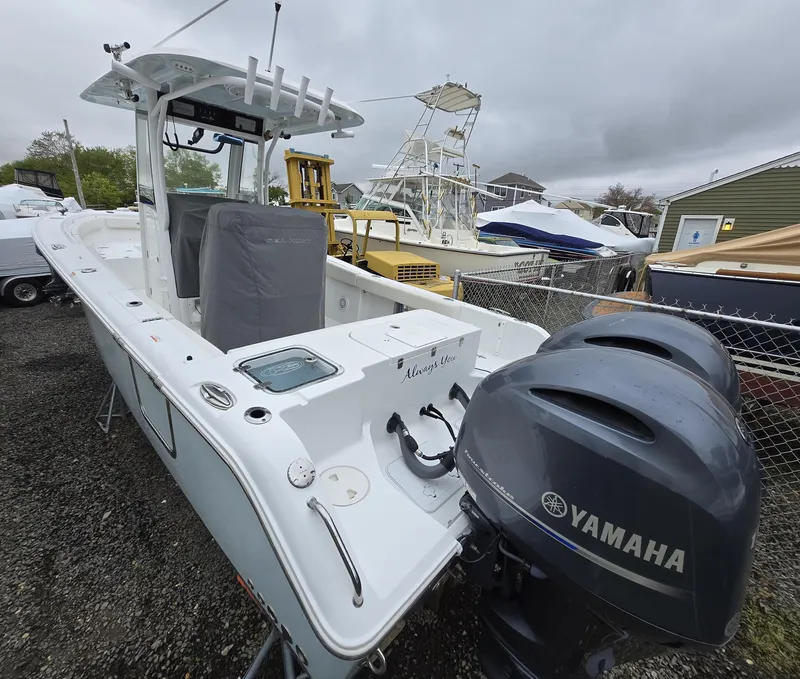 Slide: The Image of 2020 Sea Hunt Gamefish 25 boat with Yamaha engines, docked outdoors. - 25
