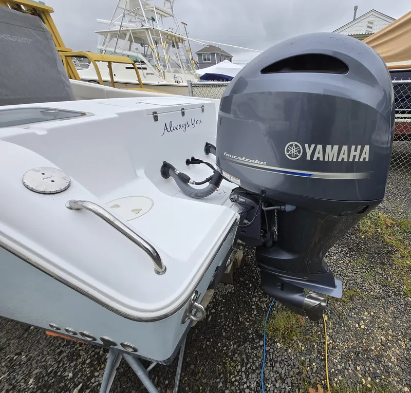 Slide: The Image of 2020 Sea Hunt Gamefish 25 with Yamaha outboard motor, parked on gravel. - 26