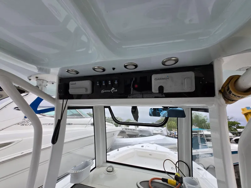Slide: The Image of 2020 Sea Hunt Gamefish 25 boat console with Garmin electronics and overhead storage. - 3