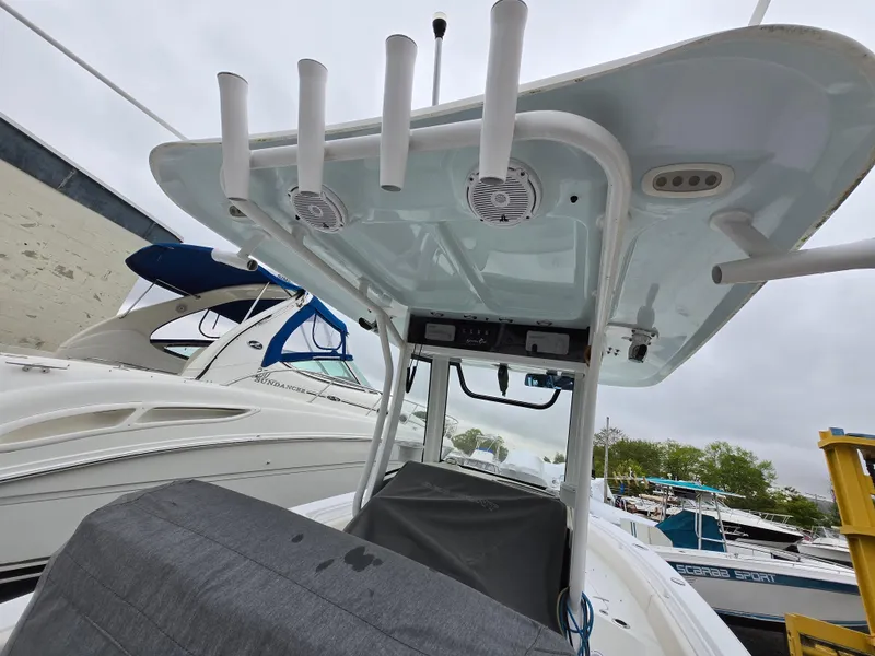 Slide: The Image of 2020 Sea Hunt Gamefish 25 boat with T-top and rod holders in marina. - 5