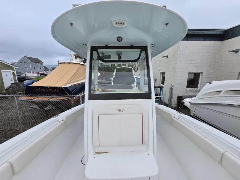 Slide: The Image of 2020 Sea Hunt Gamefish 25 boat, white interior, docked near other boats. - 7