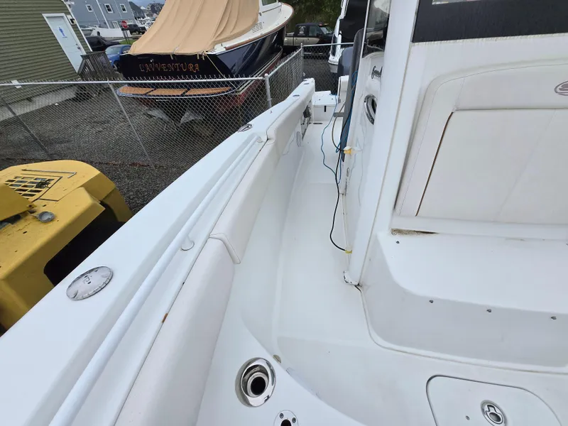 Slide: The Image of 2020 Sea Hunt Gamefish 25 boat deck, featuring white seating and fishing rod holders. - 9