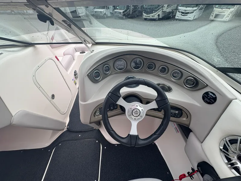 Slide: The Image of 2012 Bryant 220 boat dashboard with steering wheel and instrument panel. - 13