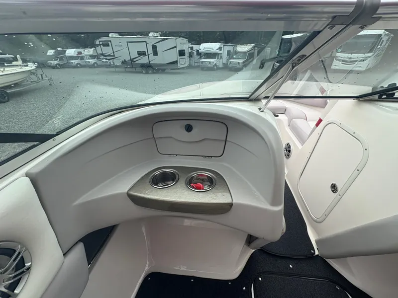 Slide: The Image of Interior view of a 2012 Bryant 220 boat with cup holders and seating. - 14