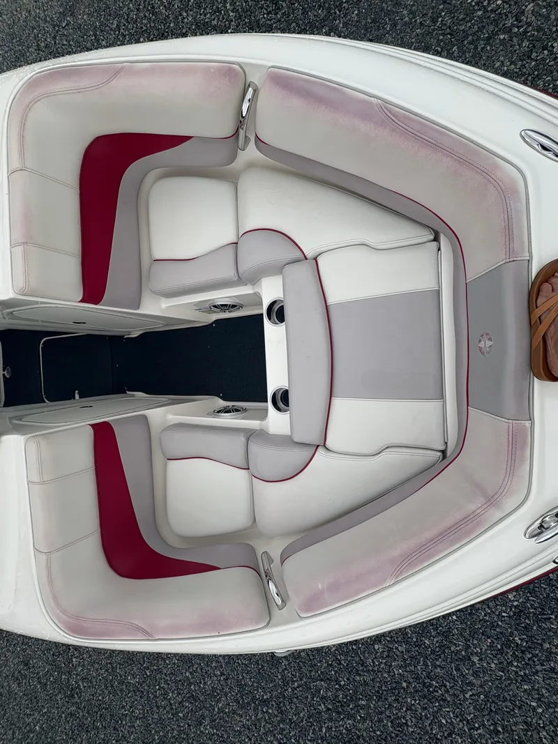 Slide: The Image of 2012 Bryant 220 boat interior with red and white seating. - 18