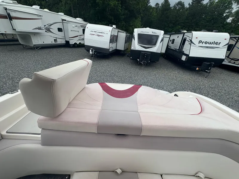 Slide: The Image of Boat interior with white and red seating, Bryant 220, 2012 model, RVs in background. - 19