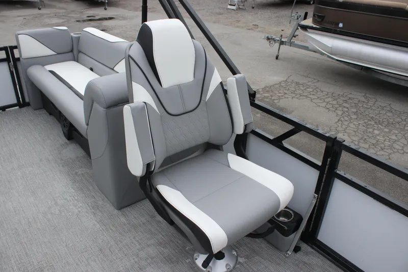 Slide: The Image of 2025 Avalon VENTURE QUAD LOUNGER boat interior with modern gray and white seating. - 7