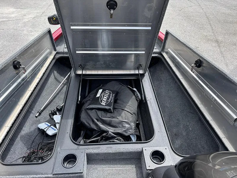 Slide: The Image of 2024 Tracker Pro Team 190 TX boat storage compartments with open lids and equipment inside. - 15
