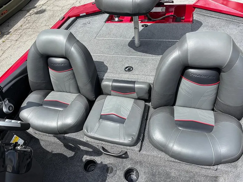 Slide: The Image of 2024 Tracker Pro Team 190 TX boat interior with gray and red seating. - 17