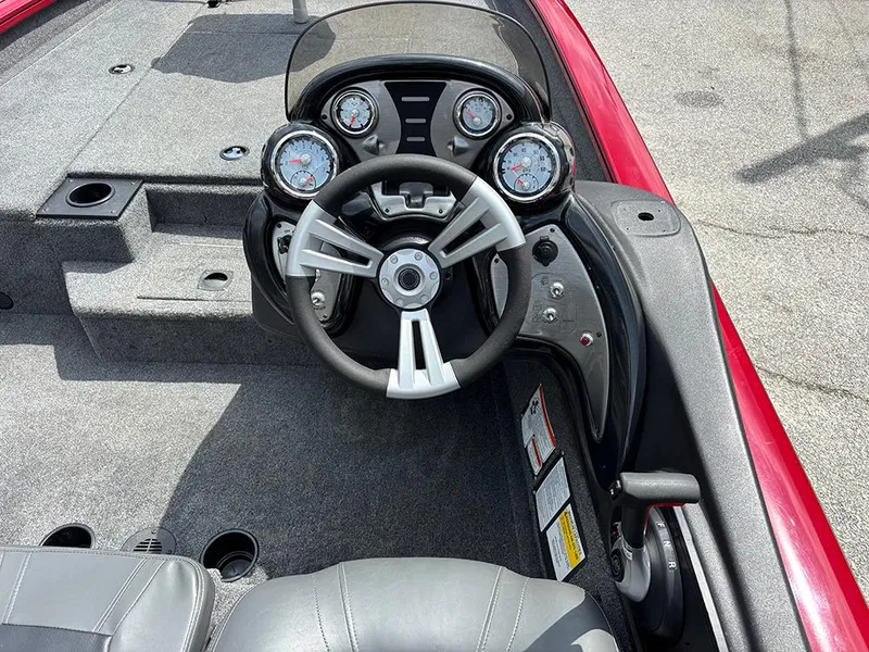 Slide: The Image of 2024 Tracker Pro Team 190 TX boat cockpit with steering wheel and instrument panel. - 19