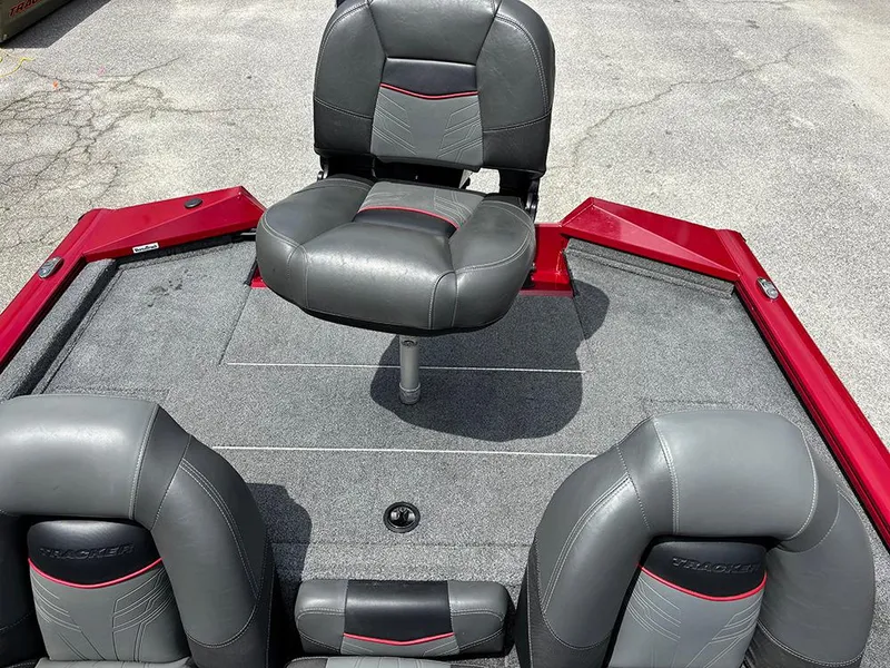 Slide: The Image of 2024 Tracker Pro Team 190 TX boat with gray and red seating on deck. - 20