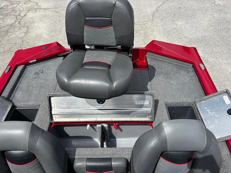 Slide: The Image of 2024 Tracker Pro Team 190 TX boat interior with gray and red seating. - 21