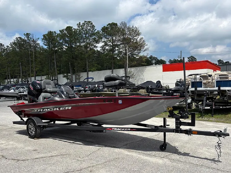 Slide: The Image of 2024 Tracker Pro Team 190 TX boat on trailer, parked outdoors under cloudy sky. - 4