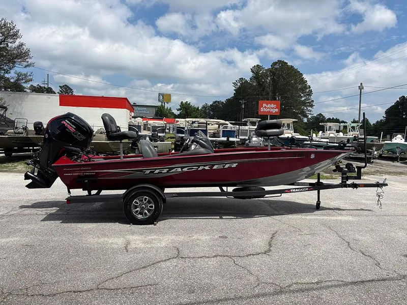 Slide: The Image of 2024 Tracker Pro Team 190 TX boat on trailer, parked outdoors under cloudy sky. - 5