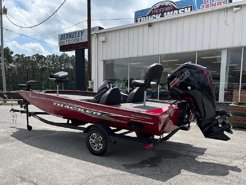 Slide: The Image of 2024 Tracker Pro Team 190 TX boat in red, parked outside Berkeley Outdoors. - 8