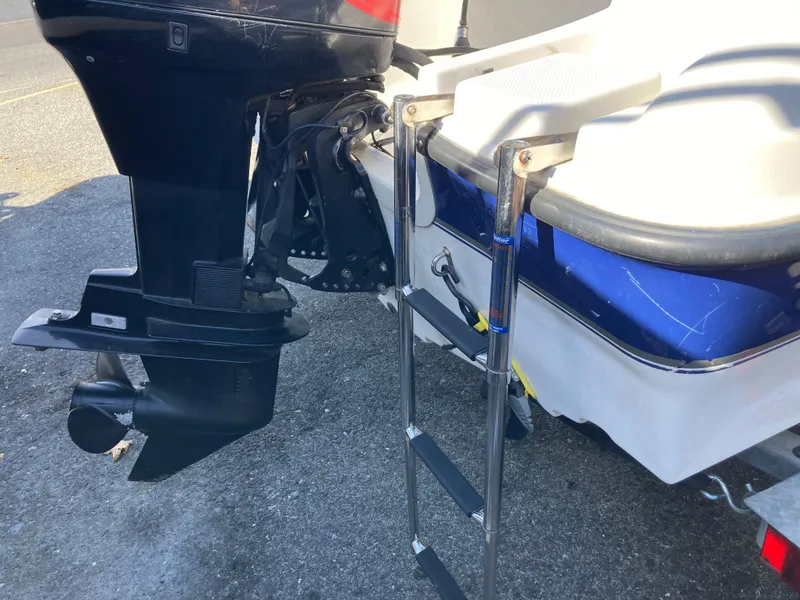 Slide: The Image of 2003 Bayliner 180 Bowrider boat with ladder and outboard motor detail. - 2