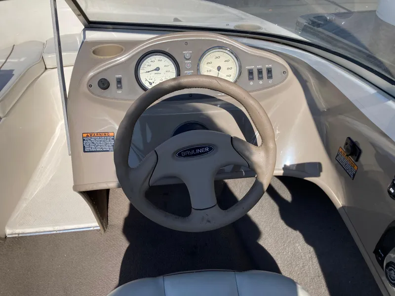 Slide: The Image of 2003 Bayliner 180 Bowrider dashboard with steering wheel and gauges. - 5