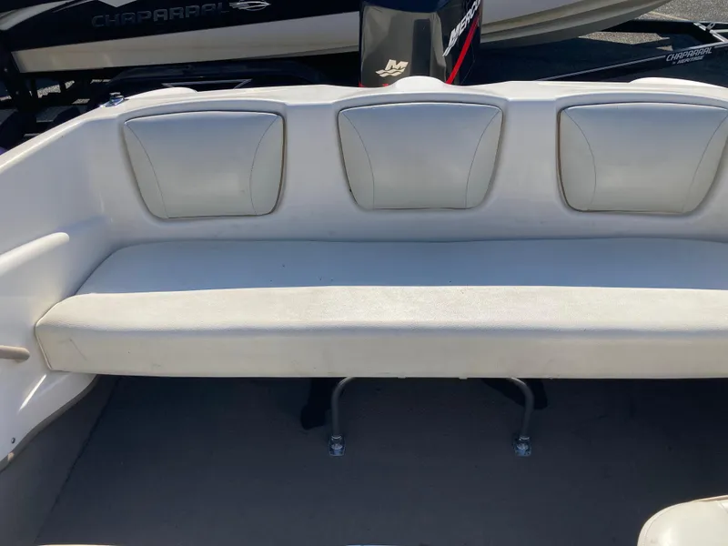 Slide: The Image of 2003 Bayliner 180 Bowrider interior with white cushioned seating. - 9
