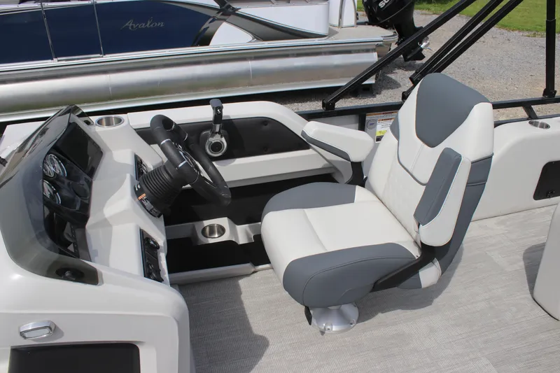 Slide: The Image of 2025 Avalon LSZ Versatile Rear Lounger boat interior with modern steering console and comfortable seating. - 6