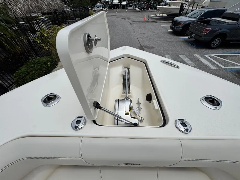 Slide: The Image of 2025 Scout 305 LXF boat anchor compartment open, showcasing storage and design features. - 16