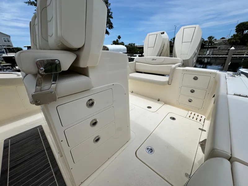 Slide: The Image of 2025 Scout 305 LXF boat interior with seating and storage compartments. - 19