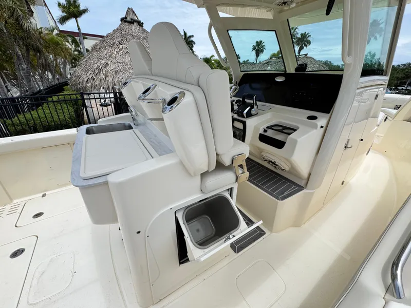 Slide: The Image of 2025 Scout 305 LXF boat interior with helm seating and storage compartments. - 20