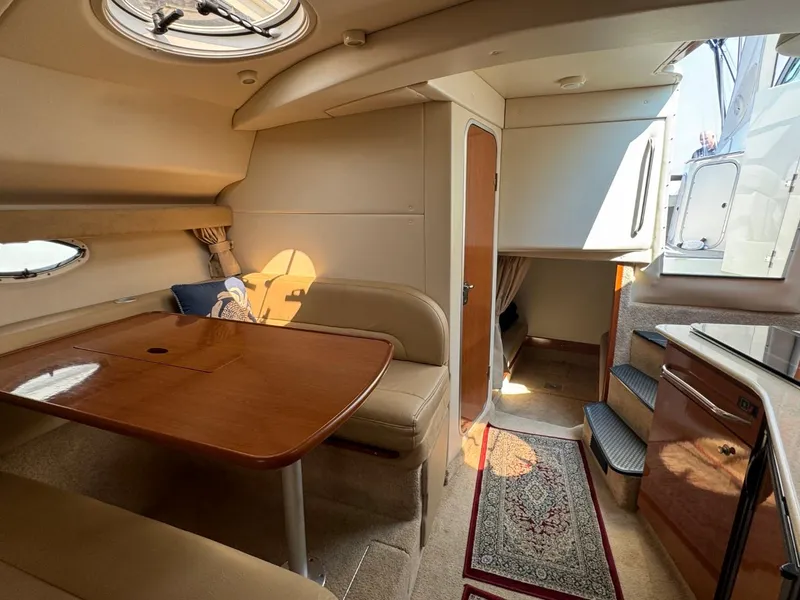 Slide: The Image of Interior of 2006 Maxum 3300 SE yacht with dining area and stairs. - 13