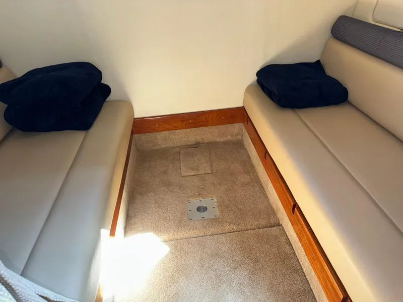 Slide: The Image of Interior cabin of 2006 Maxum 3300 SE boat with beige seating and carpeted floor. - 14