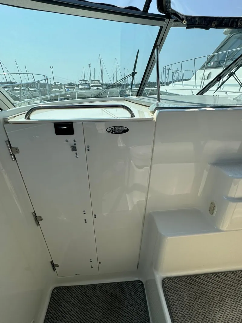 Slide: The Image of 2006 Maxum 3300 SE boat interior with white cabinetry and marina view. - 18