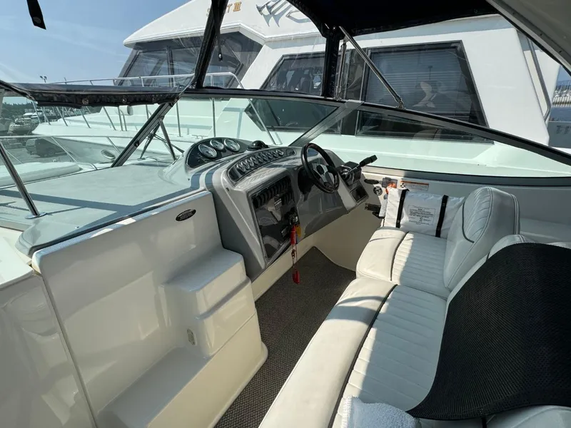 Slide: The Image of 2006 Maxum 3300 SE boat interior with steering wheel and seating area. - 19
