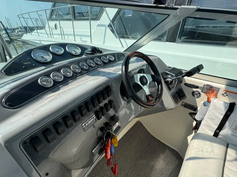 Slide: The Image of 2006 Maxum 3300 SE boat cockpit with steering wheel and control panel. - 20