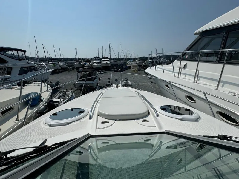 Slide: The Image of 2006 Maxum 3300 SE yacht docked at a marina, surrounded by other boats. - 21