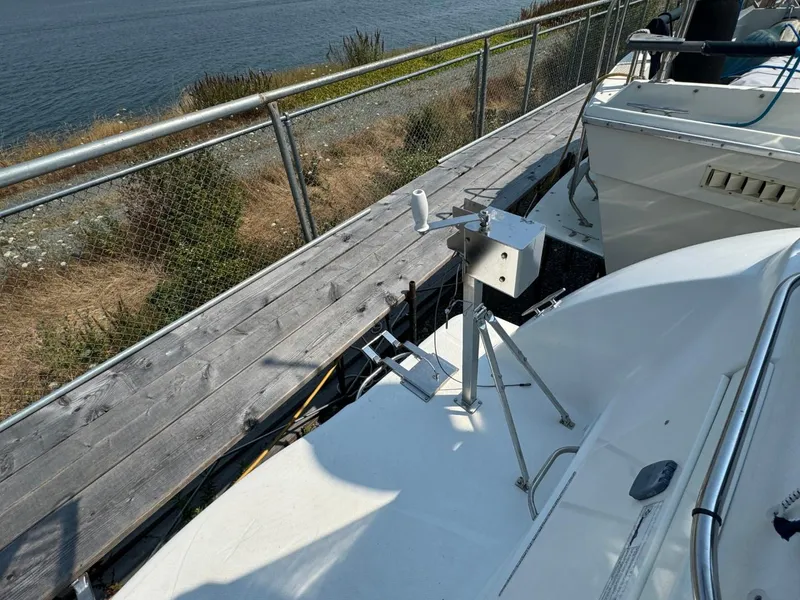 Slide: The Image of 2006 Maxum 3300 SE boat docked by a wooden walkway near the water. - 24