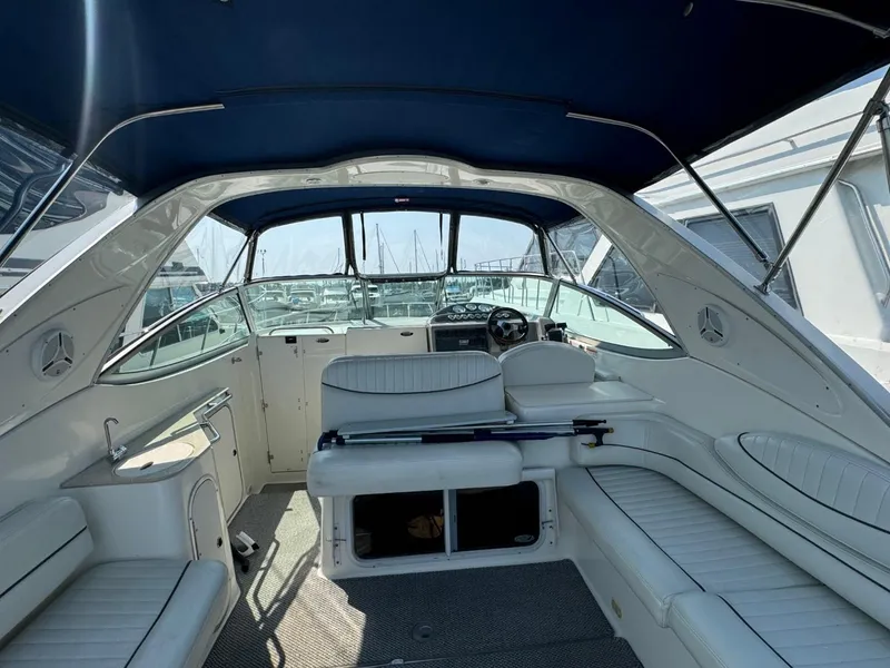 Slide: The Image of 2006 Maxum 3300 SE boat interior with white seating and blue canopy. - 25