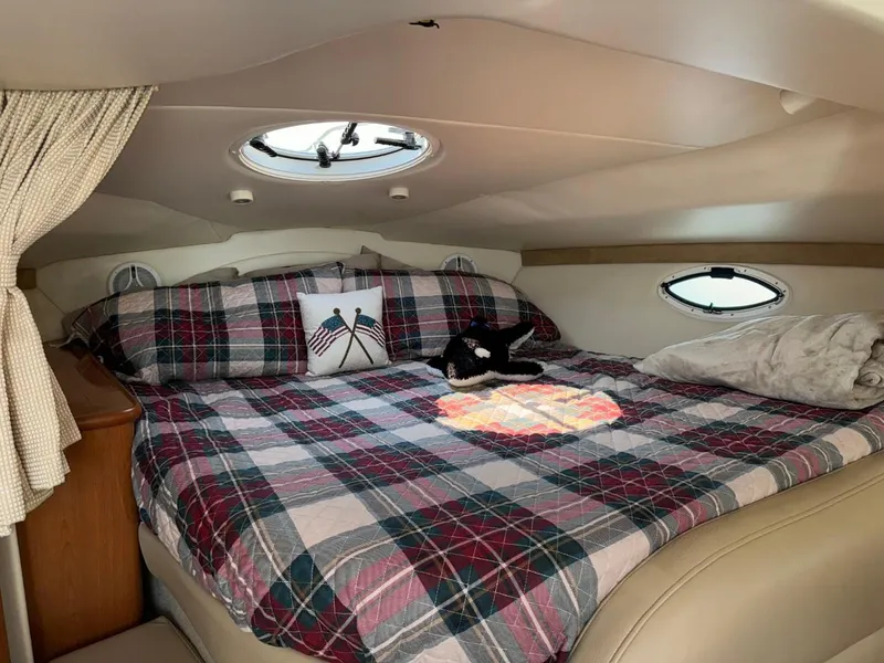 Slide: The Image of Cozy cabin interior of 2006 Maxum 3300 SE with plaid bedding and porthole windows. - 6
