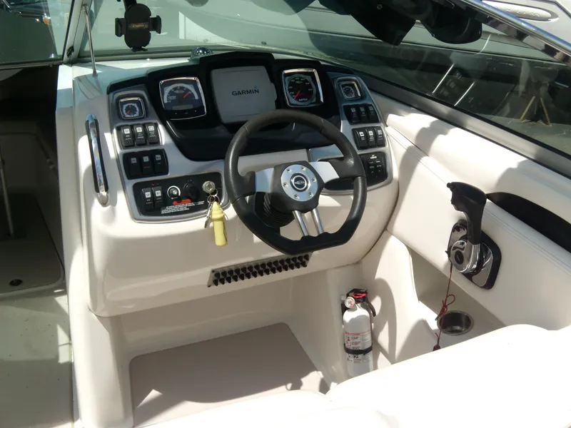 Slide: The Image of 2008 Chaparral SSX 276 boat dashboard with steering wheel and control panel. - 14