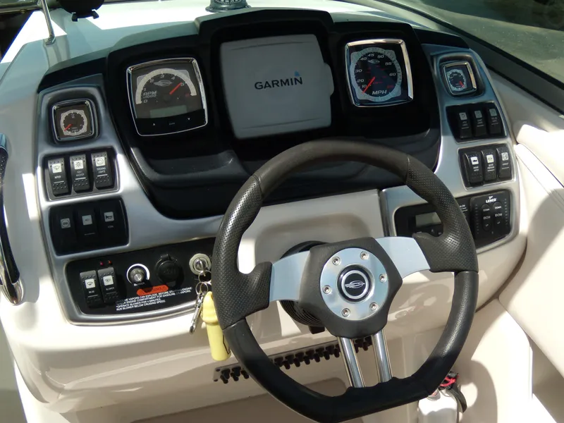 Slide: The Image of 2008 Chaparral SSX 276 boat dashboard with Garmin display and steering wheel. - 18