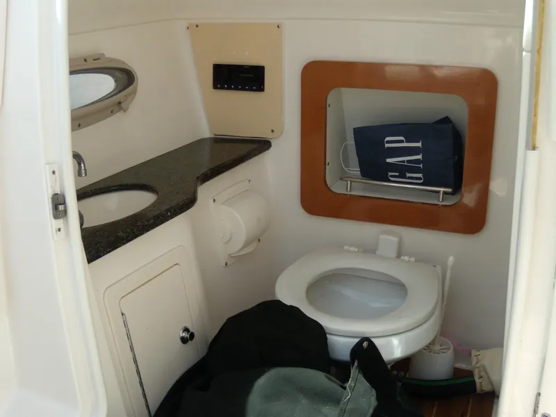 Slide: The Image of 2008 Chaparral SSX 276 boat bathroom with sink, toilet, and storage area. - 21