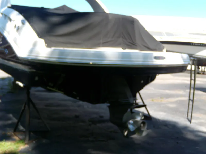 Slide: The Image of 2008 Chaparral SSX 276 boat with black cover, displayed on stands. - 3