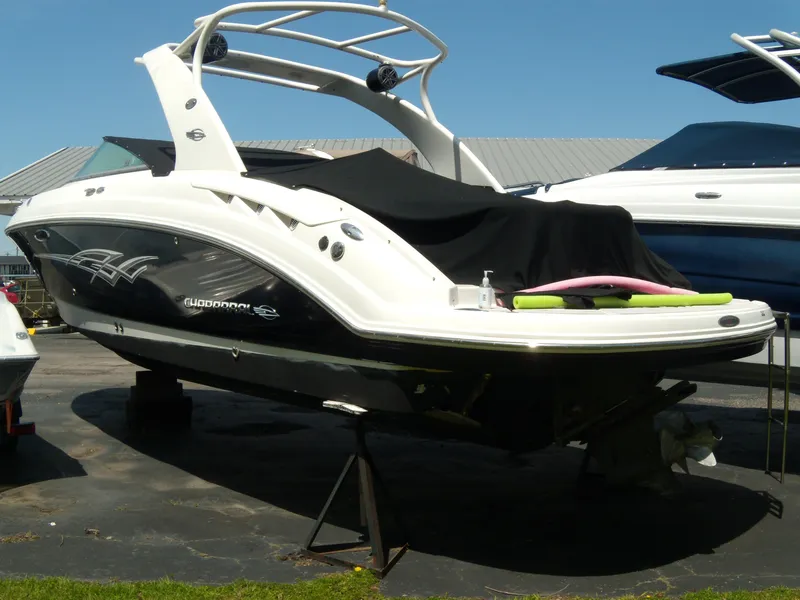 Slide: The Image of 2008 Chaparral SSX 276 boat on display, covered, with a sleek black and white design. - 30
