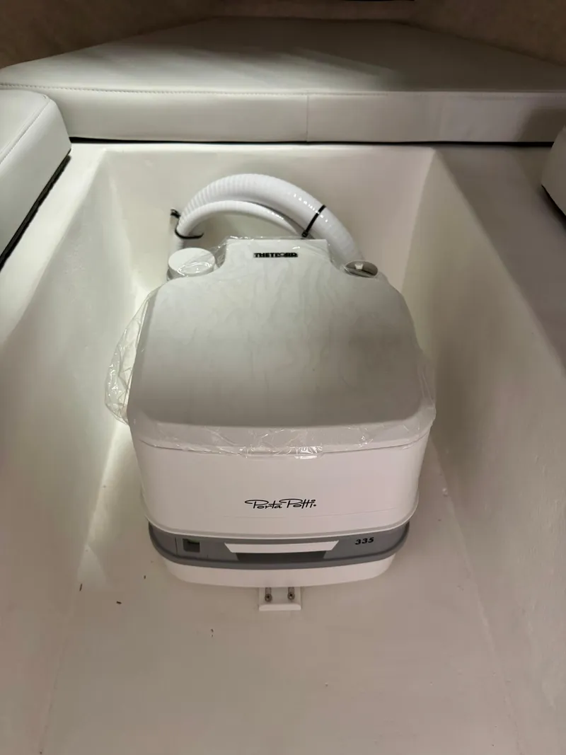 Slide: The Image of Portable toilet in 2025 Parker 2120 Sport Cabin boat interior. - 13