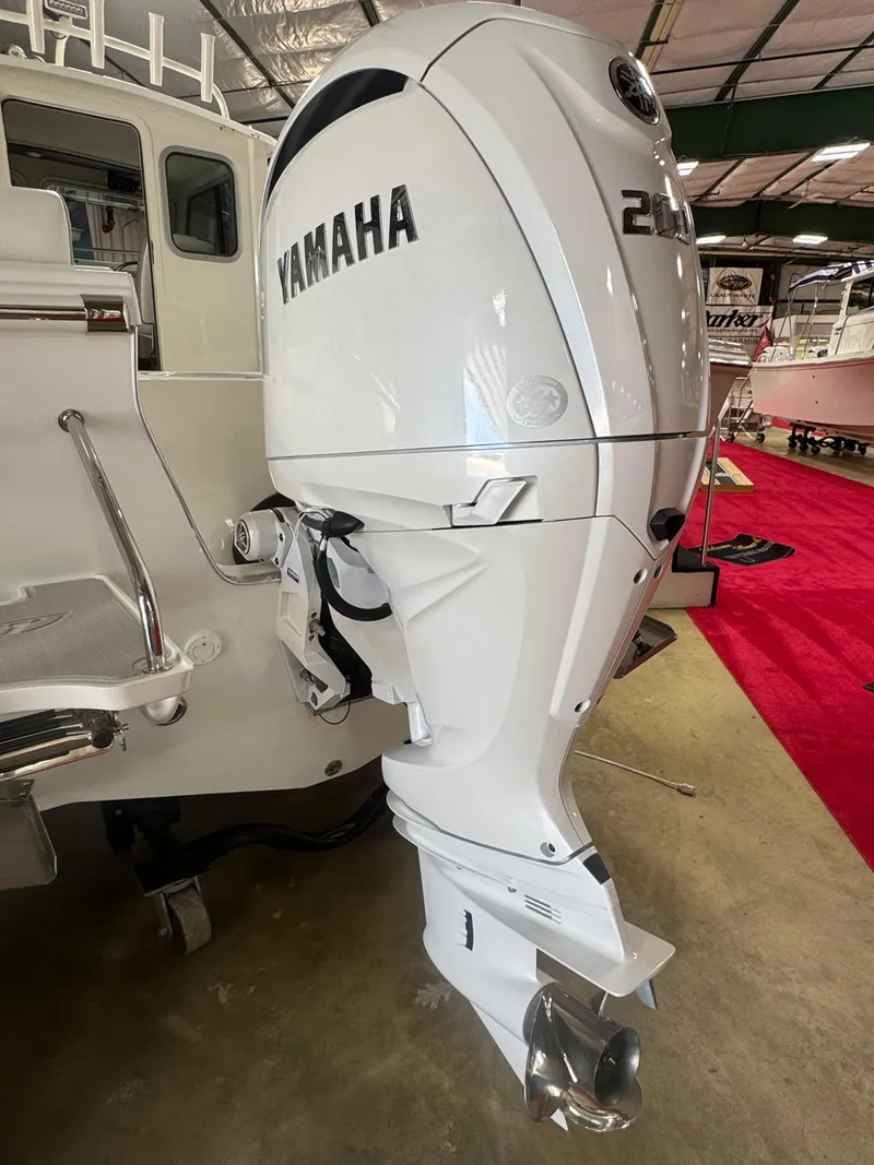 Slide: The Image of 2025 Parker 2120 Sport Cabin with Yamaha outboard motor in showroom. - 4