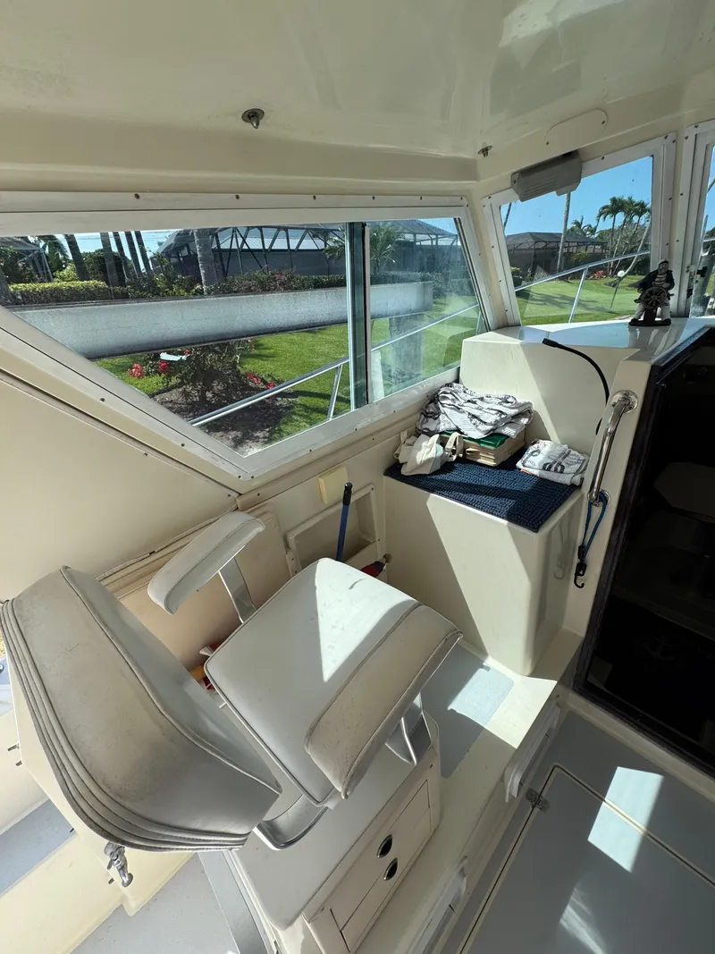 Slide: The Image of 1996 Albin Tournament Express boat interior with helm seat and windows. - 10
