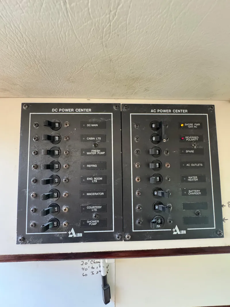 Slide: The Image of Electrical panel of a 1996 Albin Tournament Express boat, featuring DC and AC power controls. - 23